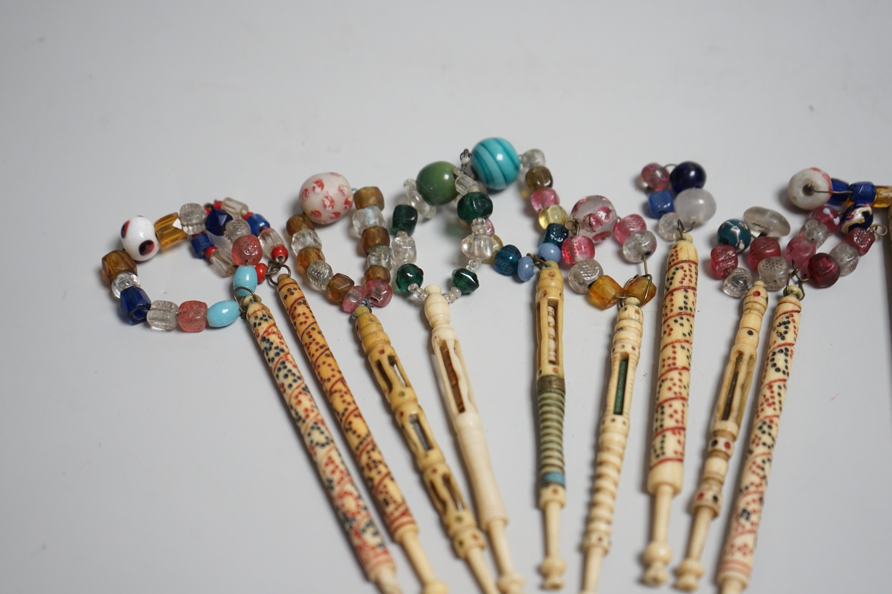 Five 19th century unusual reticulated bone lace bobbins with diagonal messages and five other ornately carved bobbins (10)